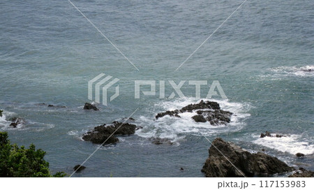 夏の日本海の岩礁と岩に当たる波 117153983