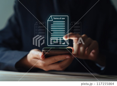 Businessman using smartphone and reading terms of service by signing to accept terms and conditions. 117155864