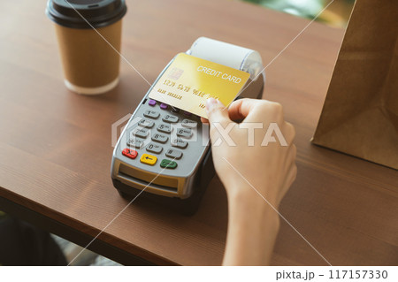 Customers using credit card touch on card swipe machine for to pay, NFC technology. Customers using credit card touch on card swipe machine for to pay, NFC technology. 117157330