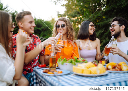 Happy friends in picnic in park. Friends grill meat, have fun, relax. ?oncept of holidays, weekends. 117157545