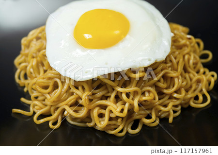 A plate of instant noodles with an egg on top A plate of instant noodles with an egg on top 117157961
