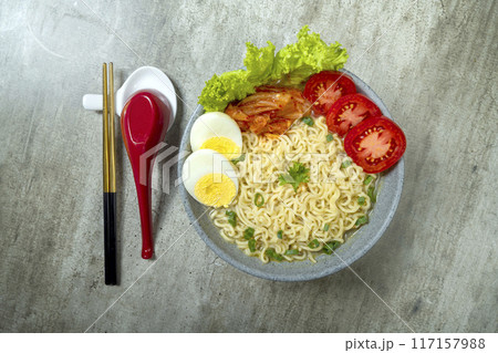 A bowl of instant noodles with eggs and tomatoes A bowl of instant noodles with eggs and tomatoes 117157988