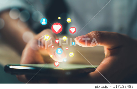 Hand holding smartphone and shows a digital screen of social media notifications. 117158485