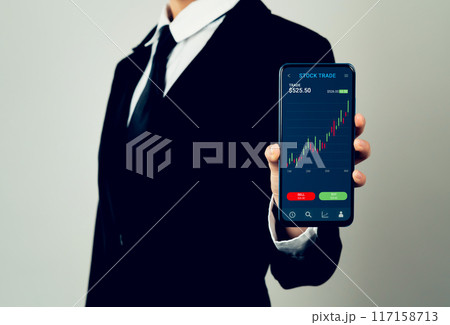 Businessman trader using smartphone with stock market investments and graph on screen to analyze trading data, buy or sell and checking price on mobile application. 117158713