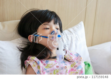 Sick little asian girl inhalation with nebulizer for respiratory treatment Sick little asian girl inhalation with nebulizer for respiratory treatment 117159148