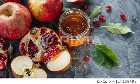 Fresh red apples, sliced pomegranate and honey 117159495