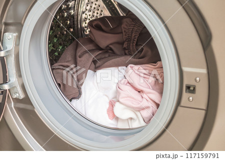 Washing machine loaded with clothes close up Washing machine loaded with clothes close up 117159791