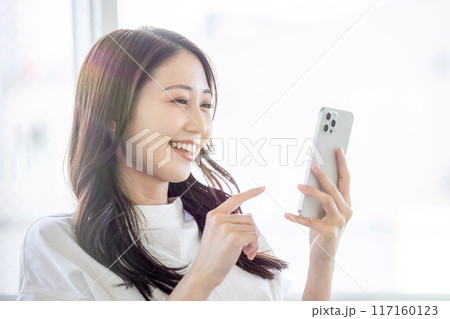 笑顔でスマホを見る女性 117160123