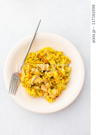 Stewed rice with chicken breast and mixed salad with radishes and various seeds 117162098
