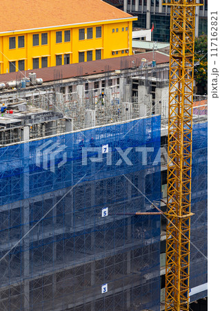 Vertical photo of new construction site with crane and mechanical equipments Vertical photo of new construction site with crane and mechanical equipments 117162821