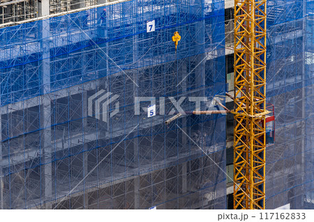 New construction site with crane and mechanical equipments New construction site with crane and mechanical equipments 117162833