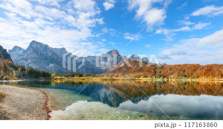 Breathtaking autumn scene of sunny morning on Almsee lake. 117163860