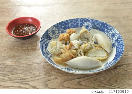 dry boiled meatball made from fish and shrimp dressing fried garlic in oil on plate dipping spicy and sour sauce 117163919
