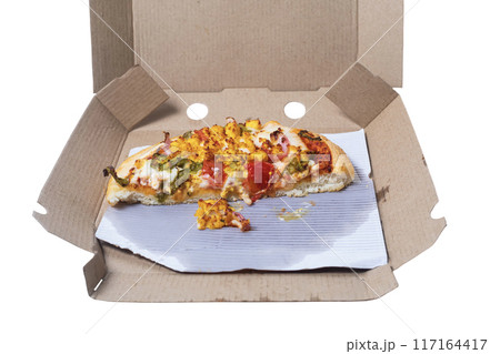 Closeup of leftover pizza in cardboard box on white background. Closeup of leftover pizza in cardboard box on white background. 117164417