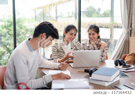Group of Student Collaboration on a Project in a Modern Study Space with Laptops and Books Group of Student Collaboration on a Project in a Modern Study Space with Laptops and Books 117164432