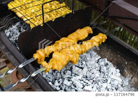 Juicy Chicken Satay on Charcoal Grill Outdoor Cooking 117164796