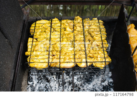 Grilled Chicken Marinated in Herbs Over Charcoal Fire 117164798