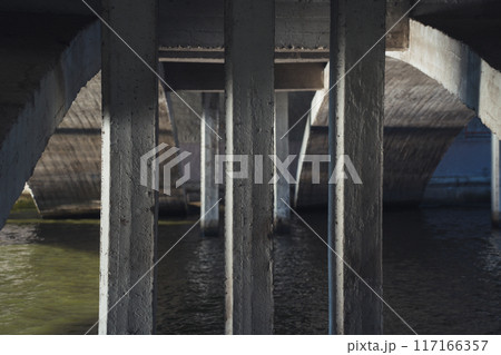 Concrete bridge supports, under the bridge over the river 117166357
