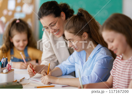 Happy kids and teacher at school Happy kids and teacher at school 117167200