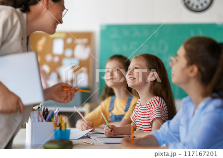 Happy kids and teacher at school Happy kids and teacher at school 117167201