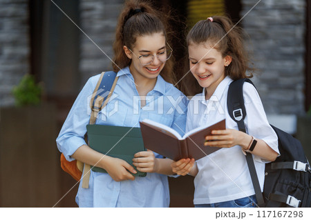 Girls with backpacks outdoors 117167298