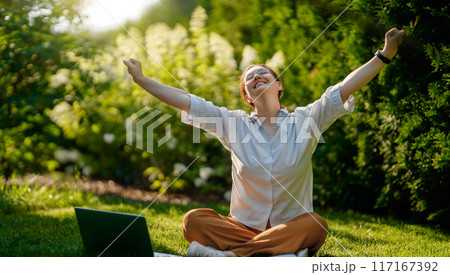 woman working on laptop in summer morning woman working on laptop in summer morning 117167392