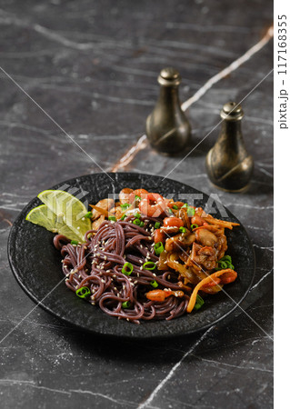 Black rice noodles with fried prawns and shrimps Black rice noodles with fried prawns and shrimps 117168355