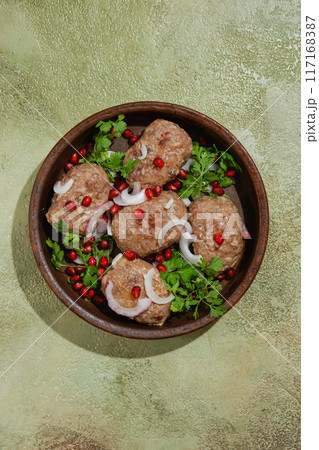 Overhead view of traditional Georgian fried meal Apkhazura in clay pot Overhead view of traditional Georgian fried meal Apkhazura in clay pot 117168387
