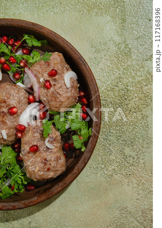 Traditional Georgian clay or stone frying pan with minced beef patties 117168396