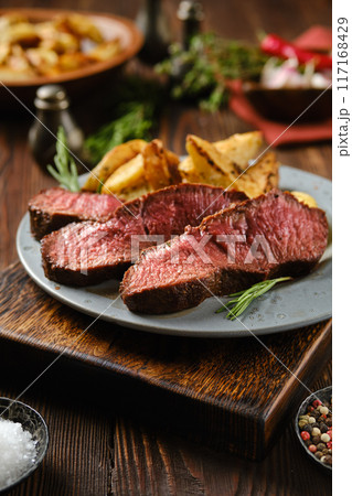Rustic dinner with juicy top blade beef steak on a plate 117168429