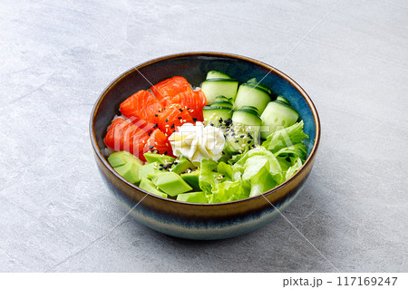Hawaiian salmon poke bowl with avocado, Top view, gray background 117169247