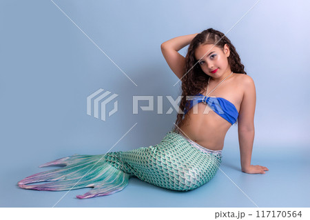 Pretty girl in a mermaid costume, isolated on a blue background. 117170564