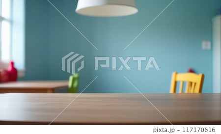 Blurred dining table with colorful chairs and blue background. 117170616