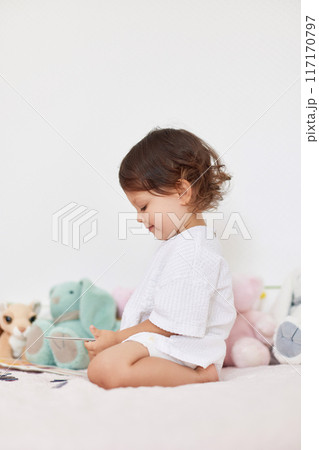 happy cute little baby girl in white t-shirt playing in her room happy cute little baby girl in white t-shirt playing in her room 117170797