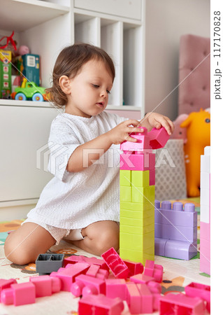 cute baby girl playing with colorful toys bricks at home cute baby girl playing with colorful toys bricks at home 117170828