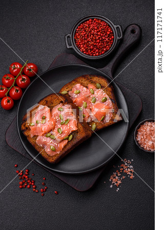 Sandwich or bruschetta with toast, salmon, cream cheese 117171741