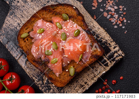 Sandwich or bruschetta with toast, salmon, cream cheese 117171983