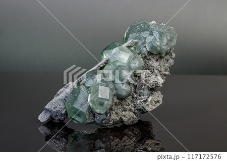 macro mineral stone green fluorite on a black background macro mineral stone green fluorite on a black background 117172576