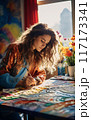 Female Artist Immersed in Vibrant Artwork 117173341