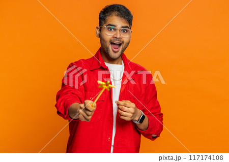 Magician wizard young man gesturing with magic wand making wish come true, casting magician spell 117174108