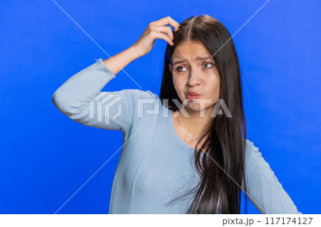 Confused woman girl feeling embarrassed about question having doubts no answer clueless uncertain 117174127