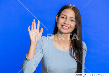 Woman showing inviting gesture with hands, ask to join, beckoning to coming, gesturing hello goodbye 117174128