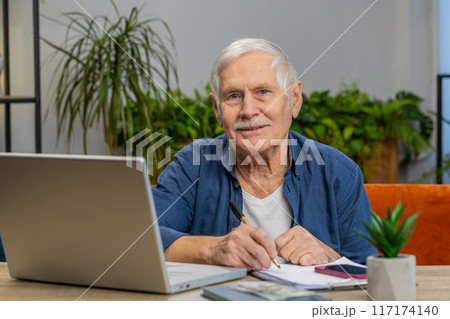 Senior man accounting payments calculating monthly expenses bank bills, analyzing paperwork at home Senior man accounting payments calculating monthly expenses bank bills, analyzing paperwork at home 117174140