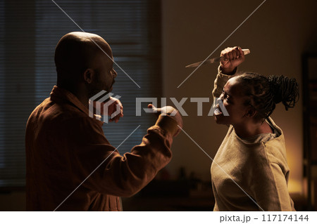 Furious couple shouting at one another 117174144