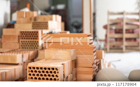 Stack of red bricks inside building under construction 117178904