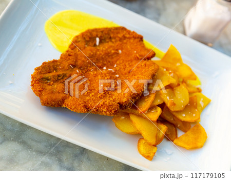 Breaded pork with potato and mustard sauce 117179105
