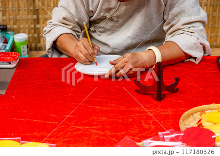 Human using brush pen and writing traditional calligraphy  117180326