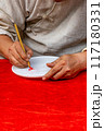 Vertical photo of human hand doing handwriting by calligraphic brush pen  117180331