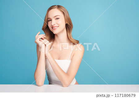 Beautiful young woman with clean fresh skin on blue background, Face care, Facial treatment, Cosmetology, beauty and spa, women portrait. Beautiful young woman with clean fresh skin on blue background, Face care, Facial treatment, Cosmetology, beauty and spa, women portrait. 117180679