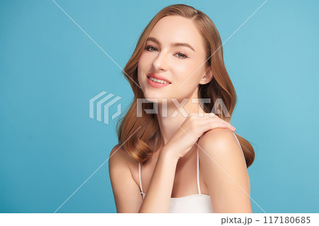 Beautiful young woman with clean fresh skin on blue background, Face care, Facial treatment, Cosmetology, beauty and spa, women portrait. 117180685